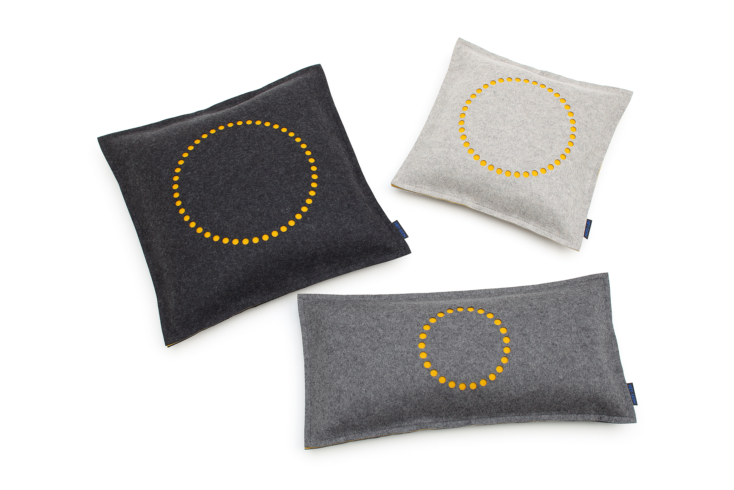 grey and black pillows with circle of yellow dots on each