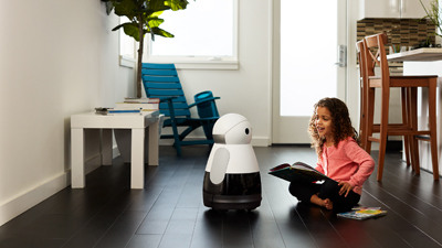 Child playing with a Kuri robot by Mayfield