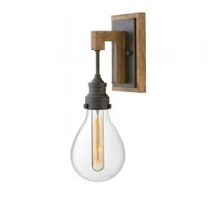 Denton wall sconce with a wood backplate and a bulb encased in glass from Hinkley Lighting