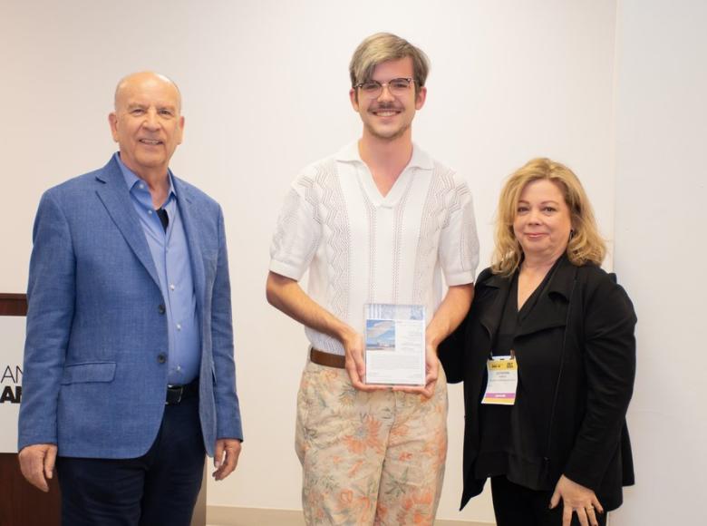 Scott Grove, center, accepts the 2024 Richard Frinier Design Scholarship from Richard and Cathy Frinier.