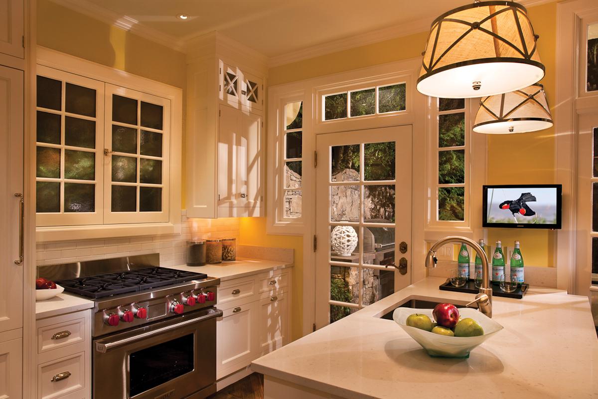 Kitchen with yellow walls and a pendant fixture