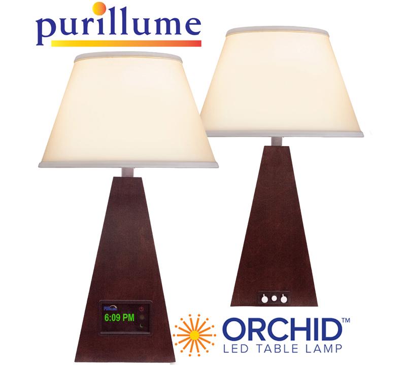 Shown here in a Cherry Wood finish, the Orchid LED table lamp from PURillume shines bright.