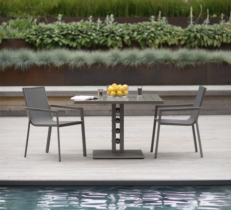 Artemis table gray table and chairs by the pool from Janus et Cie